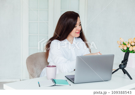Woman running online small business with laptop 109388543