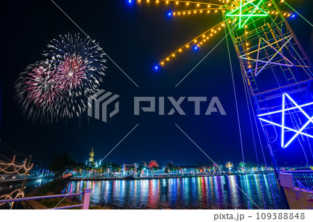 Colorful lights in the outdoor amusement park at night, Temple fair is an annual traditional festival, There is a place for religious ceremonies, Thai traditional food, and a local theme park. 109388848