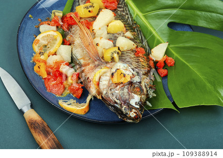 Roasted whole tilapia with citrus sauce. 109388914