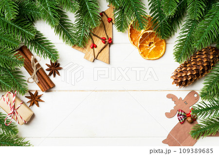 Top view of fir tree branches and festive decorative toys on wooden background. New Year time concept with empty space for your design 109389685