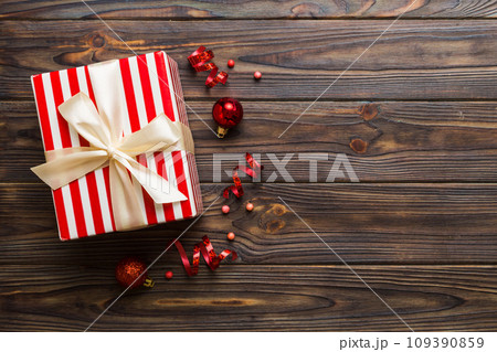 Top view Flat lay Christmas decorations and gift box on colored background with copy space. Christmas or Happy New Year composition 109390859