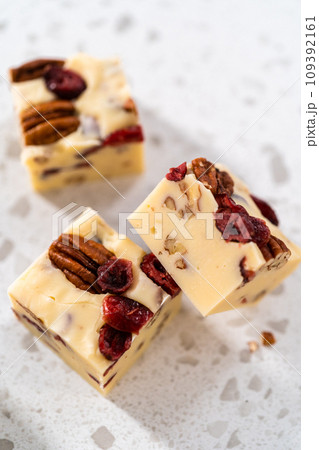 Close up view. Homemade white chocolate cranberry pecan fudge pieces on the kitchen counter. 109392161