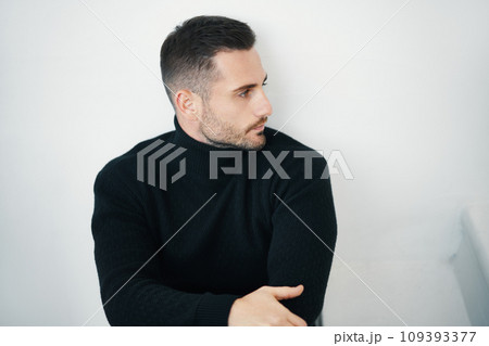 Handsome man in black stylish clothing outfit looking away 109393377