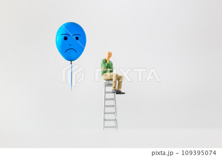 Miniature people, A despondent businessman with a blue balloon is sitting on a staircase. , Blue monday concept. 109395074