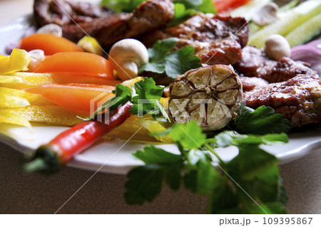 Shish kebab with mushrooms, cherry tomato and sweet pepper, Grilled meat skewers. Top view, copyspace. most important meat dish of Turkish cuisine kebabs is a rich product that is cooked on embers Shish kebab with mushrooms, cherry tomato and sweet pepper, Grilled meat skewers. Top view, copyspace. most important meat dish of Turkish cuisine kebabs is a rich product that is cooked on embers 109395867