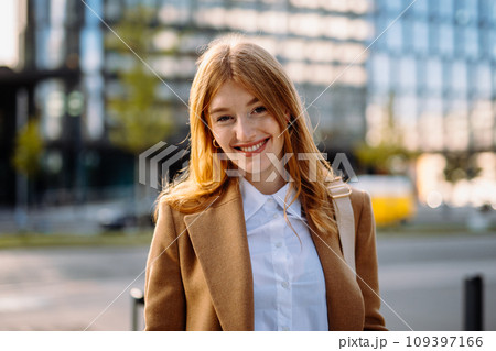 Professional Portrait of a Smiling Fashion Model in Formal Attire with Layered Hair and Fashion Accessories Professional Portrait of a Smiling Fashion Model in Formal Attire with Layered Hair and Fashion Accessories 109397166