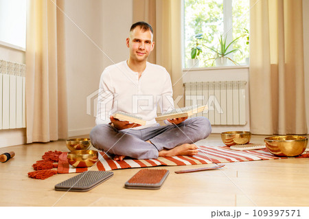 morning yoga practice with sadhu nails. mans foot on the wooden desk with sharp metal nails morning yoga practice with sadhu nails. mans foot on the wooden desk with sharp metal nails 109397571