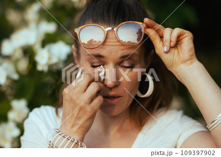 sad young female in white shirt has allergy attack sad young female in white shirt has allergy attack 109397902