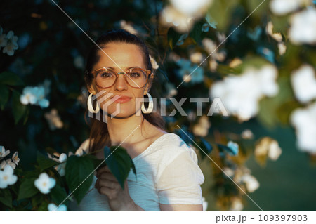 Portrait of happy modern woman in white shirt with eyeglasses Portrait of happy modern woman in white shirt with eyeglasses 109397903