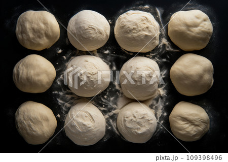 Raw dough balls and flour on black background, top view 109398496