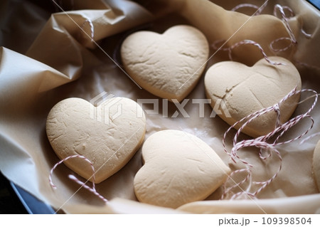 Heart shaped cookies on baking parchment paper 109398504