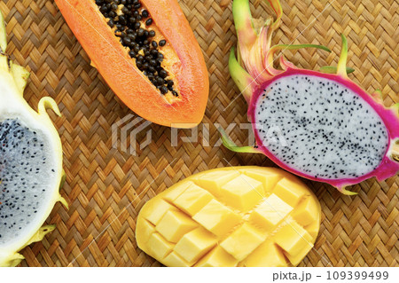 Delicious Exotic Tropic Fruits Top View on Wicker Mat Background Delicious Exotic Tropic Fruits Top View on Wicker Mat Background 109399499