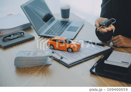 Salesman send key to customer after good deal agreement, successful car loan contract buying or selling new vehicle. 109400059