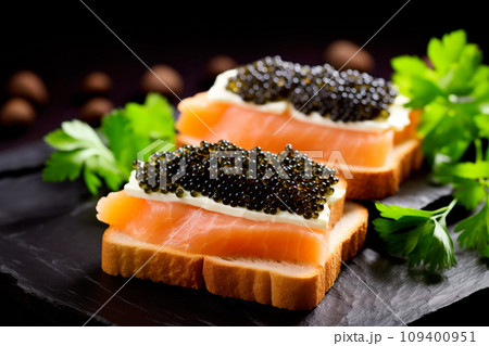 Closeup of natural black caviar served on crackers on black background, texture of fresh sturgeon caviar macro photo. 109400951