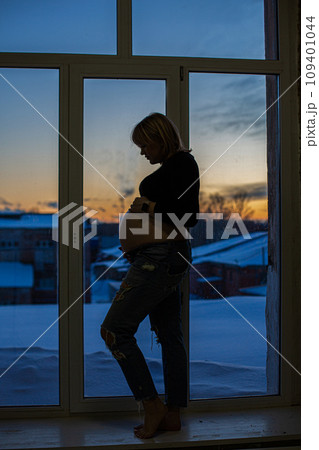 silhouette of a pregnant girl shooting on the background in the studio silhouette of a pregnant girl shooting on the background in the studio 109401044
