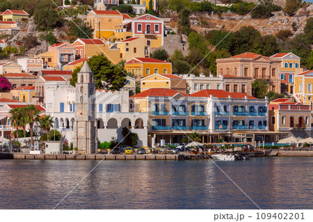 Multi-colored facades of houses in the village Symi on a sunny day. Multi-colored facades of houses in the village Symi on a sunny day. 109402201