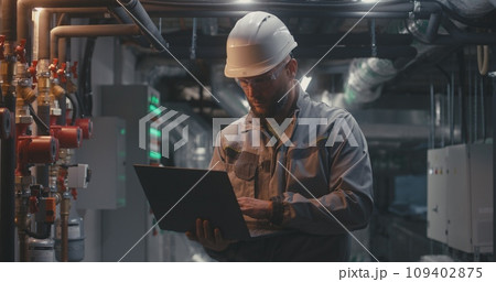Factory specialists work using laptop and tablet computers 109402875
