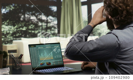 Wealthy shareholder connects on laptop to support his staff from his high end alpine retreat. Business owner examines worldwide profit statistics for banking administration at deluxe lodging. Wealthy shareholder connects on laptop to support his staff from his high end alpine retreat. Business owner examines worldwide profit statistics for banking administration at deluxe lodging. 109402980