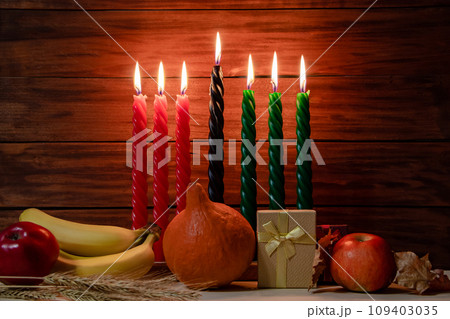 Happy Kwanzaa. Seven candles red, black and green on wooden background. Happy Kwanzaa. Seven candles red, black and green on wooden background. 109403035