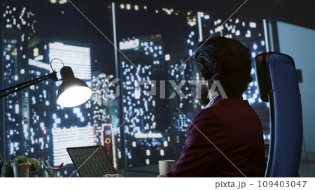 Investment banking analyst evaluating fiscal projections and managing funding deals to support expanding company on global scale. Skilled consultant seeks to boost earnings, admiring metropolis view. 109403047