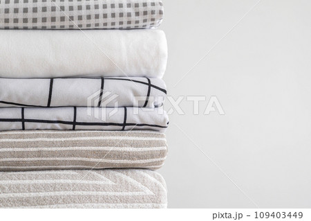 Pile of folded bed sheets and blankets Pile of folded bed sheets and blankets 109403449