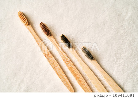 Toothbrushes on a white terry towel. 109411091