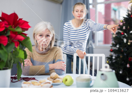 Daughter angry with elderly mother on Christmas night at home 109413627