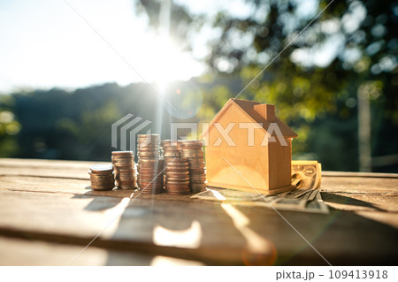 Saving money home, stacked money and savings house on the table Saving money home, stacked money and savings house on the table 109413918