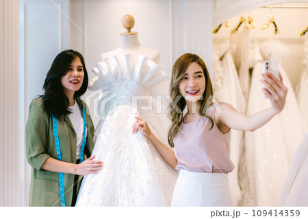 Female bridal store owner work in wedding studio shop.  109414359