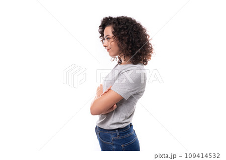 portrait of a young upset serious 30 year old caucasian woman in a gray t-shirt standing sideways on portrait of a young upset serious 30 year old caucasian woman in a gray t-shirt standing sideways on 109414532