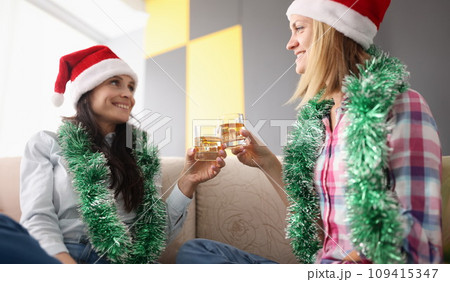 wo happy woman clink glasses. 109415347