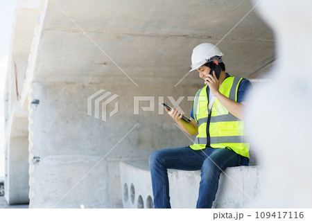 Professional senior Asian civil engineer working at the heavy infrastructure construction site, civil engineer - foreman inspecting the segmentation construction bridge. 109417116