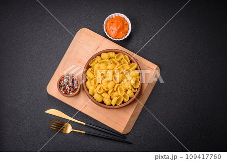 Raw durum wheat gnocchi pasta with salt and spices in a ceramic plate 109417760