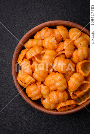 Delicious fresh pasta with pesto sauce, salt, spices and herbs on a ceramic plate Delicious fresh pasta with pesto sauce, salt, spices and herbs on a ceramic plate 109417785