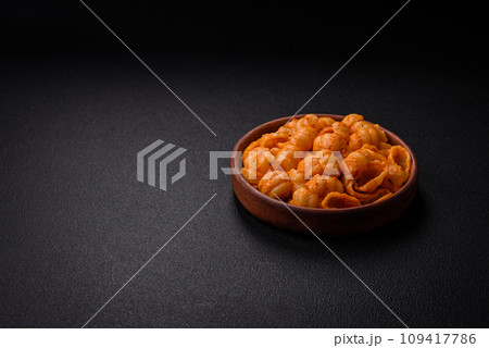 Delicious fresh pasta with pesto sauce, salt, spices and herbs on a ceramic plate 109417786