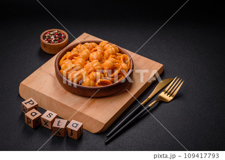 Delicious fresh pasta with pesto sauce, salt, spices and herbs on a ceramic plate Delicious fresh pasta with pesto sauce, salt, spices and herbs on a ceramic plate 109417793