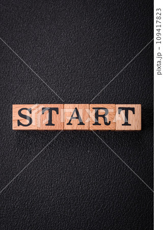The inscription start on wooden cubes on a dark concrete background 109417823