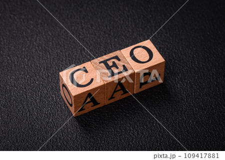 The inscription ceo in wooden cubes on a dark concrete background 109417881