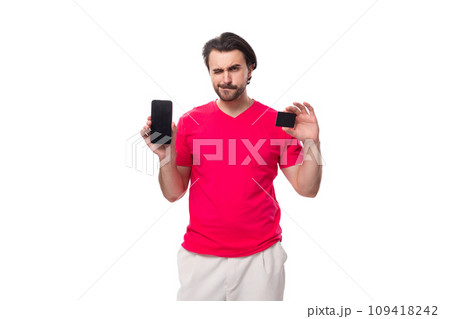 young smart well-groomed slender brunette man with a cool hairstyle dressed in a red T-shirt young smart well-groomed slender brunette man with a cool hairstyle dressed in a red T-shirt 109418242