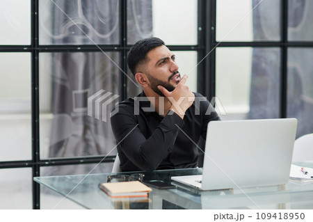 Middle-aged man working on laptop in office Middle-aged man working on laptop in office 109418950