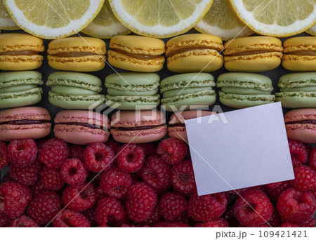macaroons of different colors with raspberries and lemon macaroons of different colors with raspberries and lemon 109421421