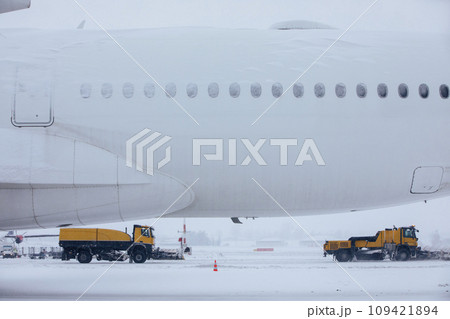 Winter frosty day at airport during heavy snowfall. Winter frosty day at airport during heavy snowfall. 109421894