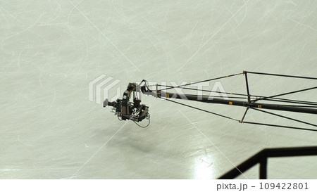 The camcorder on the crane works in the ice arena. 109422801