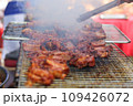 Closeup of man cooking grilled ribs on the grill in the market 109426072