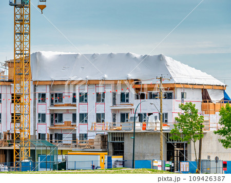 New low-rise residential building under construction on blue sky background New low-rise residential building under construction on blue sky background 109426387