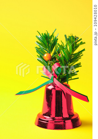Vertical Red Christmas bells on a yellow background 109428010