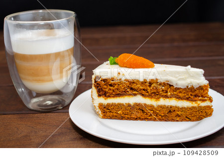Carrot sponge cake with cream and walnuts and Cappuccino coffee Carrot sponge cake with cream and walnuts and Cappuccino coffee 109428509