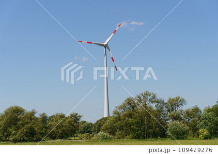 Landscape from renewable energy wind turbine with field, forest and sky Landscape from renewable energy wind turbine with field, forest and sky 109429276