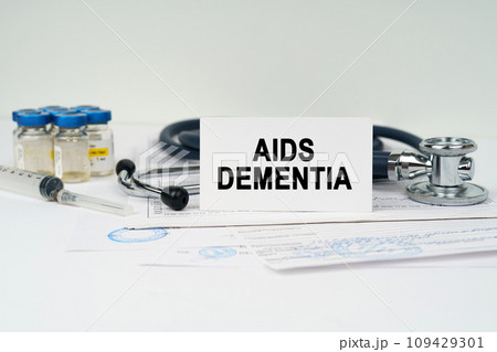 On the medical documents there is a stethoscope, syringe and a business card with the inscription - AIDS DEMENTIA On the medical documents there is a stethoscope, syringe and a business card with the inscription - AIDS DEMENTIA 109429301