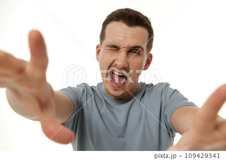 portrait of young happy man winking looking at the camera on white background 109429341